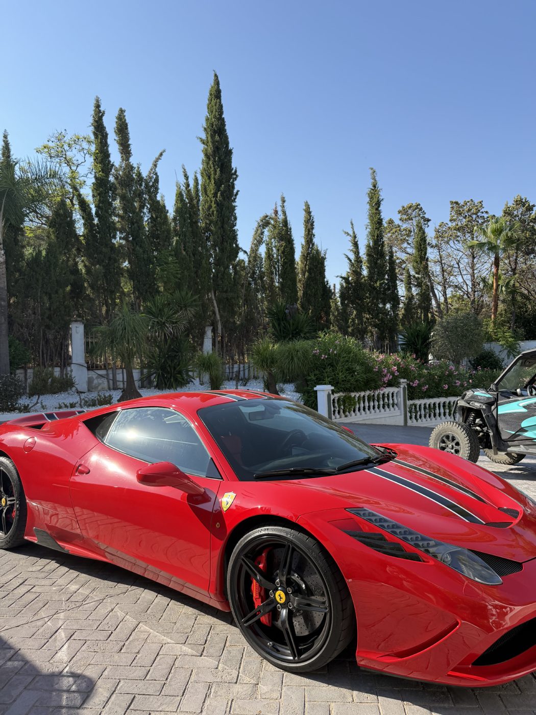 Red Ferrari at a villa